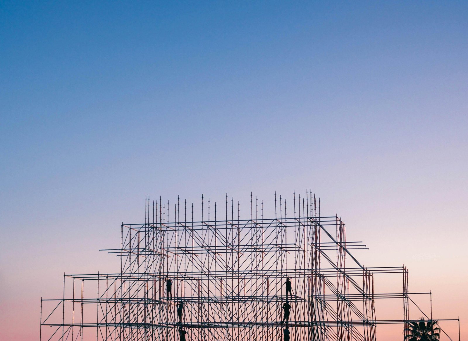 Industrial steel structure silhouetted at sunset